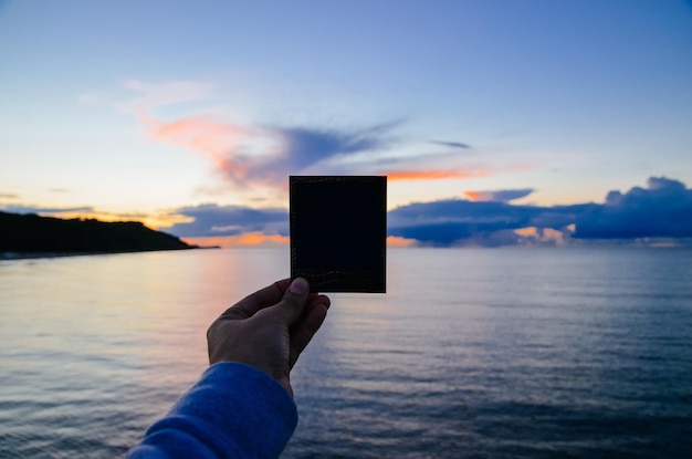 Cropped image of man overlooking sea