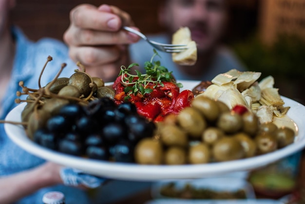 Photo cropped image of man taking food from plate