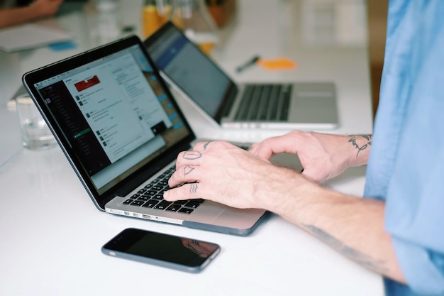 Cropped image of man using laptop