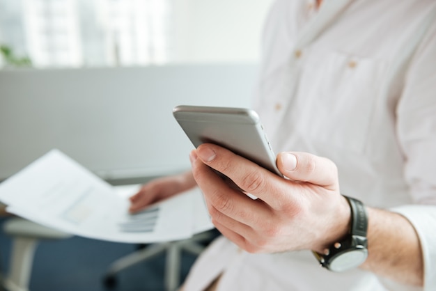 Cropped image of man using phone