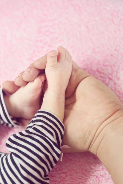 Photo cropped image of parent and baby girl on rug