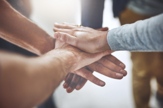 Cropped image of people stacking hands