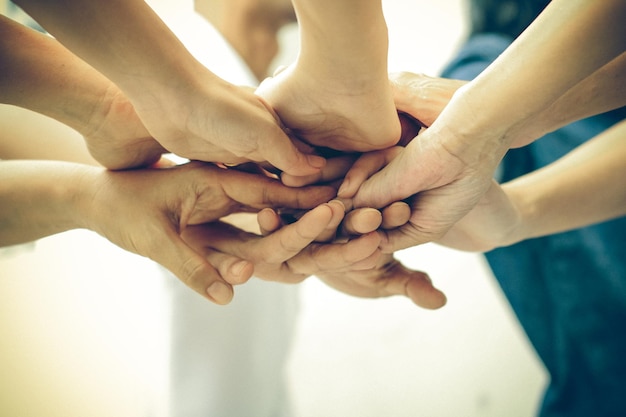Cropped image of people with stacked hands
