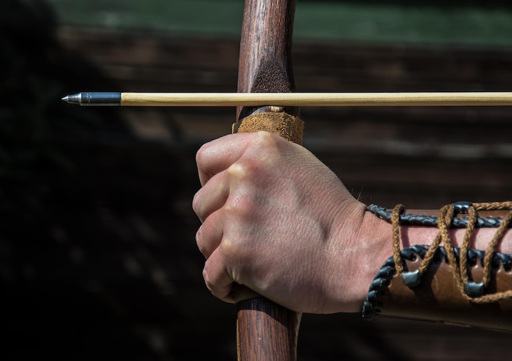 Photo cropped image of person aiming with bow and arrow
