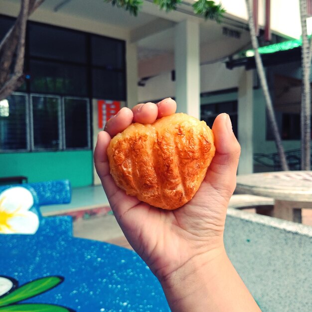 Cropped image of person holding apple