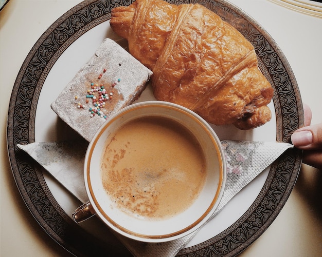 Cropped image of person holding breakfast in plate