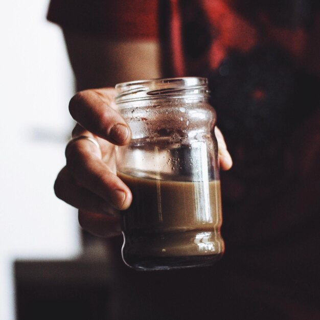 Cropped image of person holding coffee cup