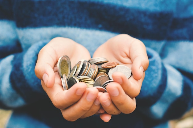 cropped image of person holding coins