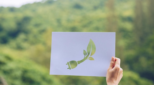 Photo cropped image of person holding paper against plants