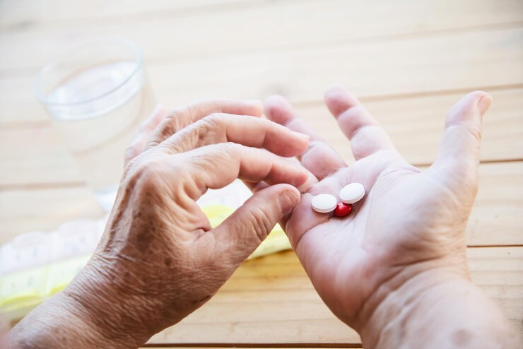 Photo cropped image of person holding pills