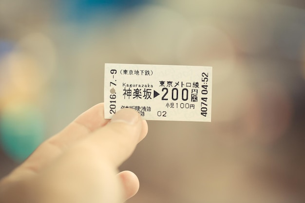 Photo cropped image of person holding train ticket