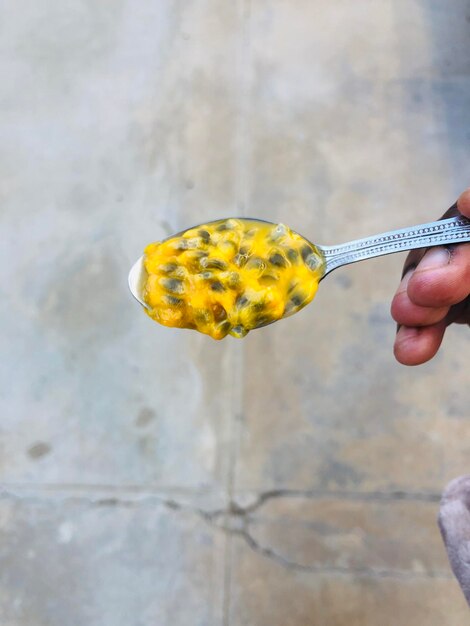 Cropped image of person holding yellow leaf