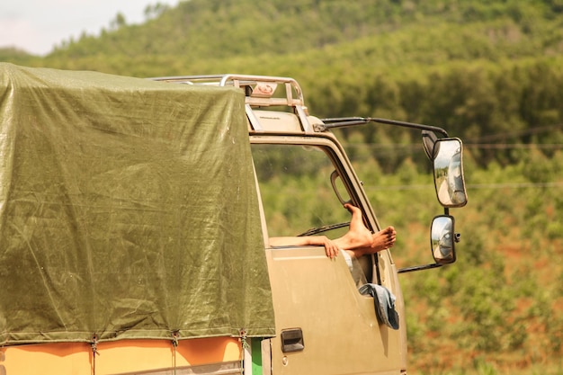 Photo cropped image of person sitting in vehicle