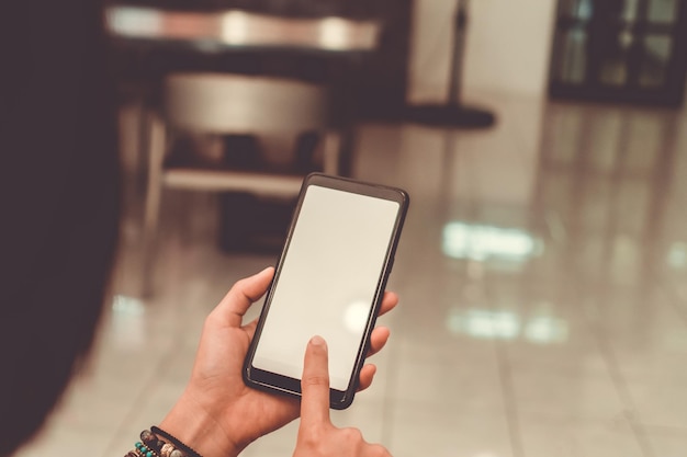 Cropped image of person using smart phone