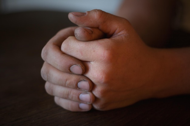 cropped image of person with hands clasped