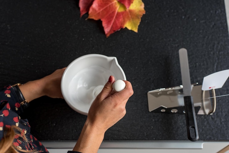 Photo cropped image of pharmacist preparing medicine using mortar and pestle