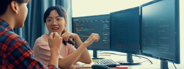 Cropped image of professional programer team collaboration discuss about web coding while coworker point java script displayed on computer at modern company office Closeup Burgeoning