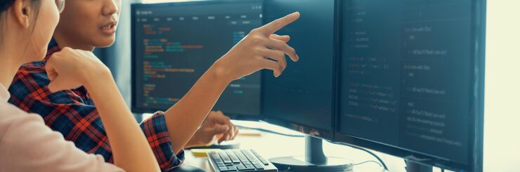 Photo cropped image of professional programer team collaboration discuss about web coding while coworker point java script displayed on computer at modern company office closeup burgeoning