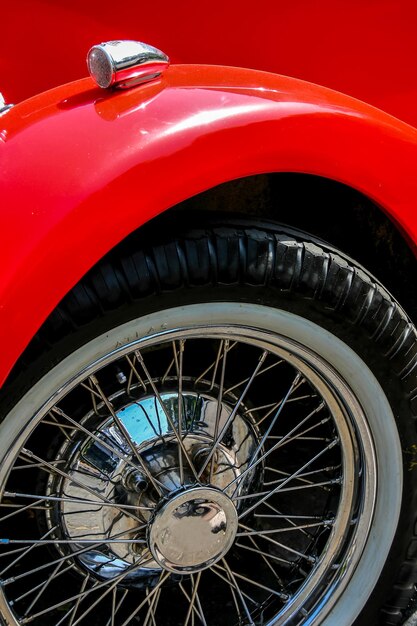 Cropped image of red vintage car wheel