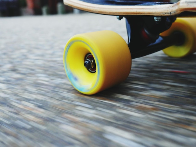 Photo cropped image of skateboard moving on street