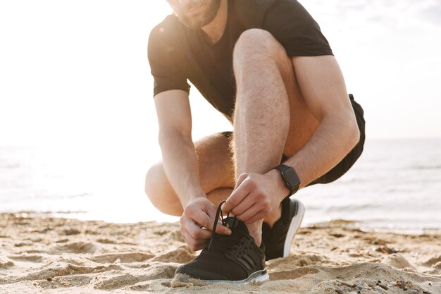 Cropped image of a sportsman tying shoelaces