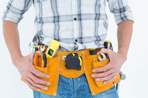 Cropped image of technician with tool belt around waist