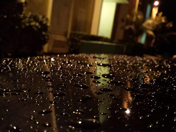 Photo cropped image of wet car in yard at night