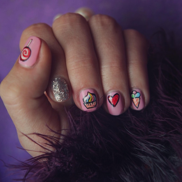 Photo cropped image of woman hand with nail art