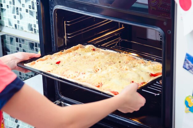 Cropped image of woman keeping food in microwave