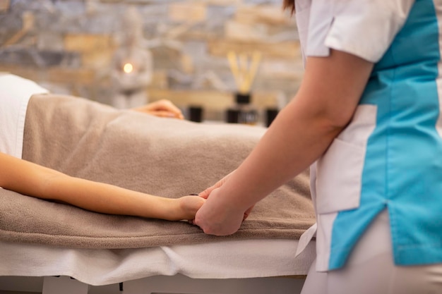 Cropped image of woman receiving hand massage at spa Horizontal view