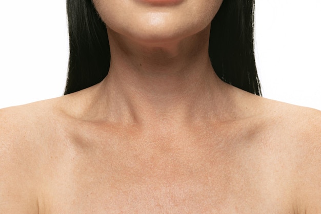 Cropped image of woman's neck shoulders isolated over white studio background Plastic surgery concept