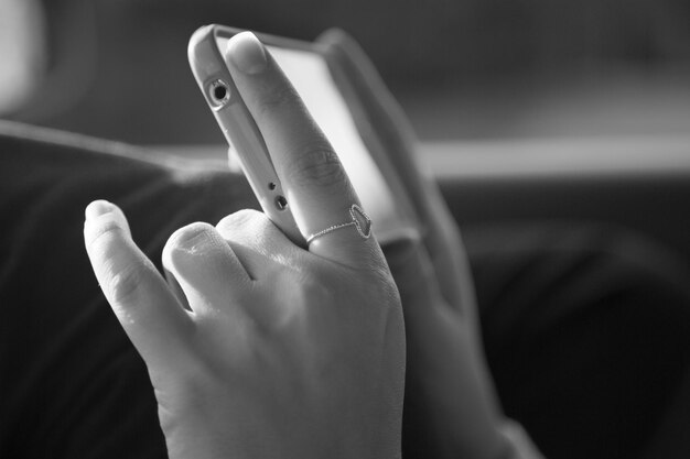 Photo cropped image of woman using smart phone