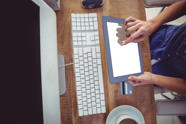 Cropped image of woman using tablet