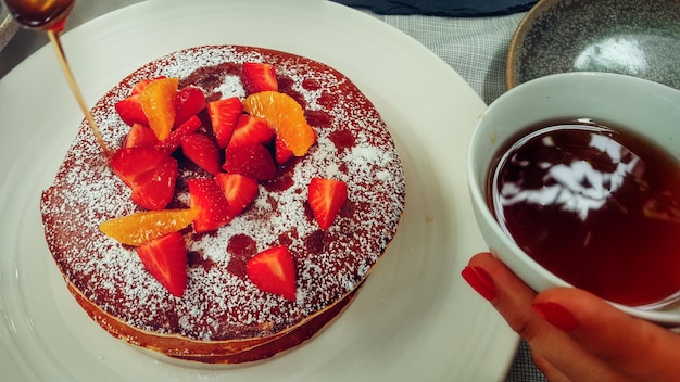 パンケーキを食べている女性のカットされた画像