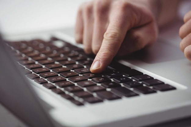 Cropped man working on laptop