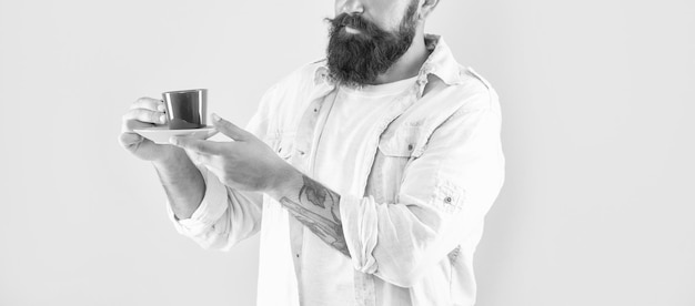 Cropped mature hipster with beard holding coffee cup on yellow background coffee cup