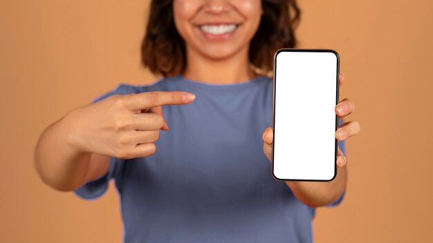 Photo cropped of middle eastern woman pointing at smartphone