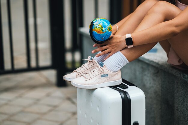 Cropped photo Beautiful young woman holds a small globe