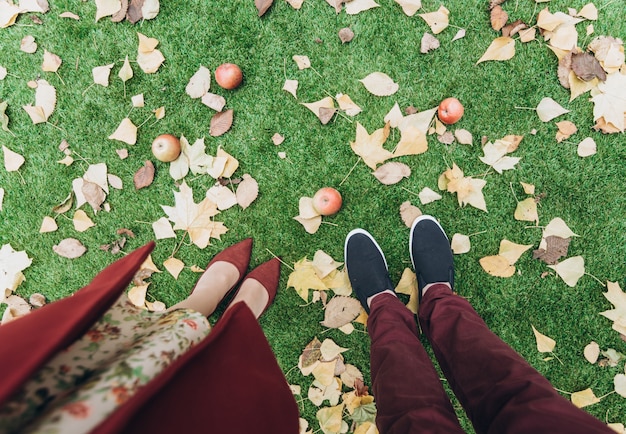 Cropped photo of the couple man and woman standing and walking at the romantic date. Love outdoor lifestyle with nature on background