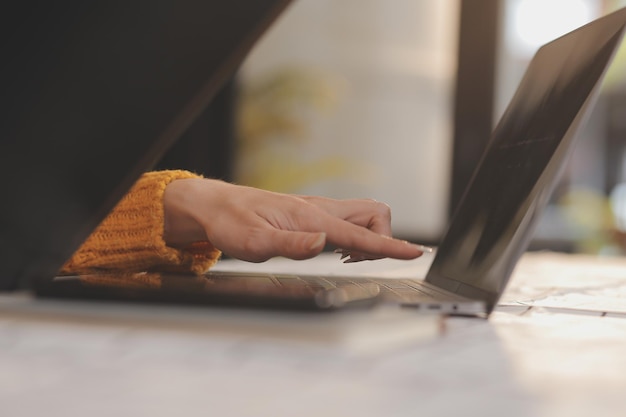 Cropped photo of Freelancer business Asian woman holding coffee cup and at doing planning analyzing the financial report business plan investment finance analysis the workplace