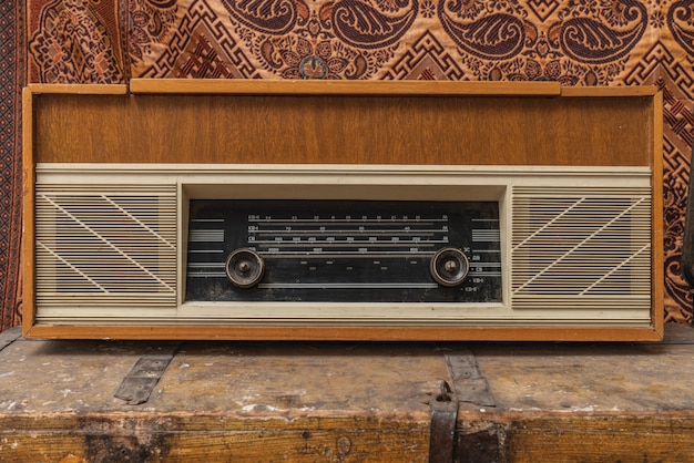 Cropped photo of a retro, old vintage radio music on the coffe table