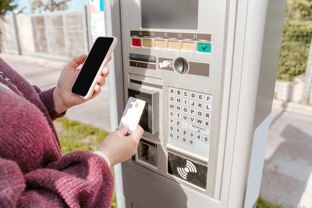 Cropped photo of a woman paying with a credit card for fuel at the self-service gas station