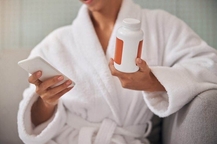 Photo cropped photo of woman without face holding a telephone and pills