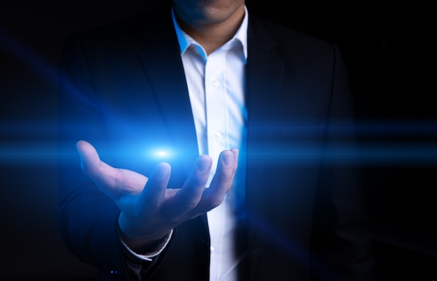 Photo cropped portrait of asian businessman reaching out to grab a halo