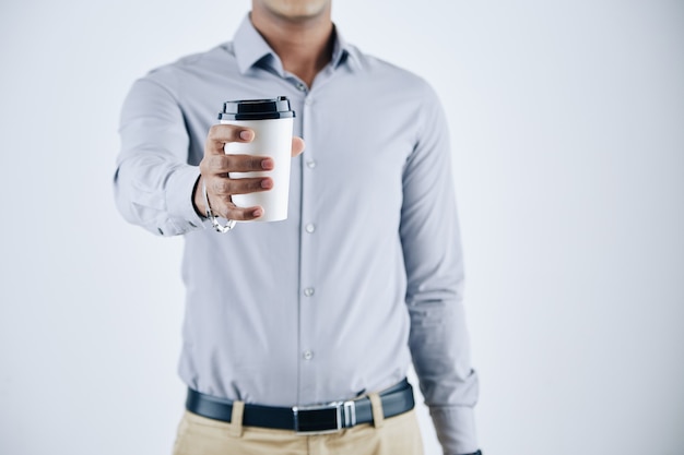 Cropped portrait of entrepreneur outstretching hand with cup of take away coffee, isolated on white