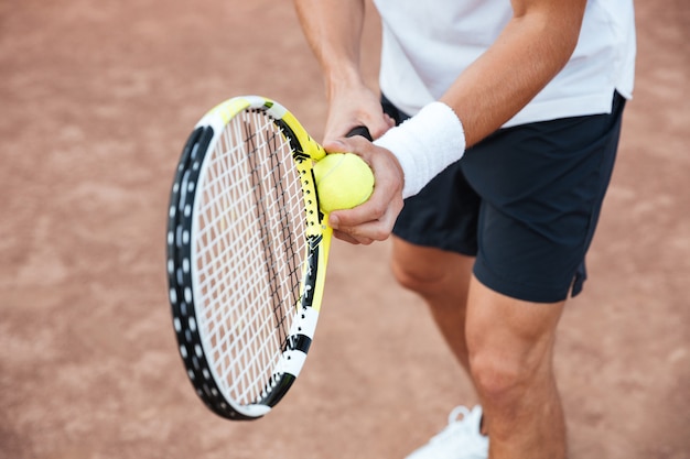 Cropped portrait of tennis player on court