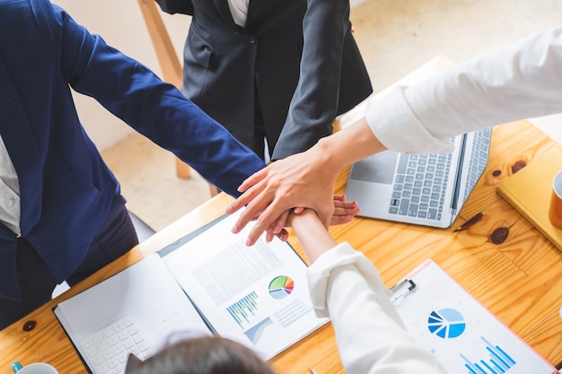 Photo cropped shop of business people stacking hands for startup new project