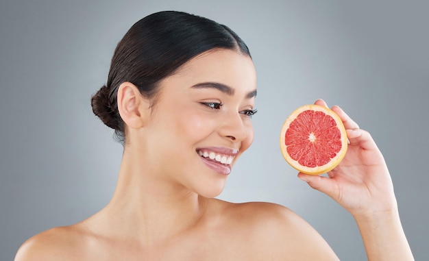 Cropped shot of an attractive young woman posing in studio against a grey background