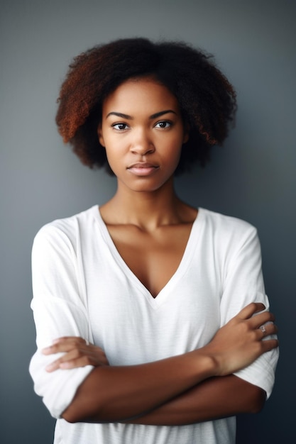 Photo cropped shot of a beautiful young woman standing with her arms folded