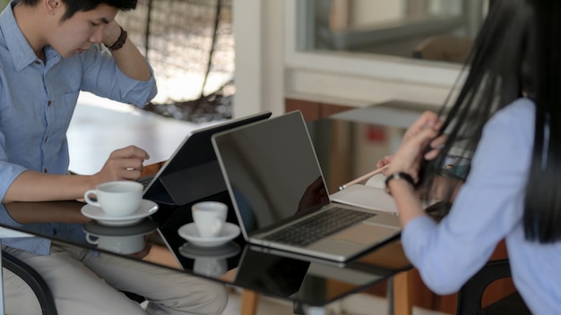 Cropped shot of businesspeople focusing on their work with laptop